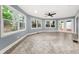 Sunroom with large windows, neutral paint, and ceiling fan at 3900 Millwood Lane Nw, Lilburn, GA 30047