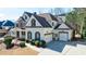 Angle view of a beautiful two-story home featuring a two-car garage, well-manicured landscaping, and inviting curb appeal at 4978 Millwood Dr, Canton, GA 30114