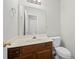 Bathroom with dark wood vanity, modern fixtures and a large mirror at 5555 Clover Rise Ln, Norcross, GA 30093