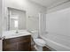 Bathroom features a dark wood vanity, a white toilet and a shower and tub combination at 5555 Clover Rise Ln, Norcross, GA 30093