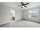 Bedroom with ceiling fan, two windows, and attached office space at 5555 Clover Rise Ln, Norcross, GA 30093