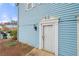 Townhouse exterior featuring light blue siding and a white front door at 5555 Clover Rise Ln, Norcross, GA 30093