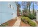 Townhouse exterior with blue siding, dual doors, and landscape at 5555 Clover Rise Ln, Norcross, GA 30093