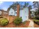 Exterior of townhouse with fenced-in backyard, mature trees, and a well-maintained lawn at 5555 Clover Rise Ln, Norcross, GA 30093