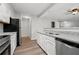 Updated kitchen featuring stainless steel appliances, granite countertops and white cabinetry at 5555 Clover Rise Ln, Norcross, GA 30093