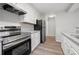 Modern kitchen design with stainless steel appliances, granite countertops, and white cabinets at 5555 Clover Rise Ln, Norcross, GA 30093