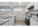 Well-lit kitchen with granite countertops, stainless steel appliances and white cabinetry at 5555 Clover Rise Ln, Norcross, GA 30093