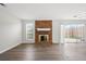 Spacious living room featuring a fireplace, new flooring, and a sliding glass door at 5555 Clover Rise Ln, Norcross, GA 30093