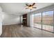 Open living room with fireplace, ceiling fan, sliding glass doors to the patio, and updated flooring at 5555 Clover Rise Ln, Norcross, GA 30093