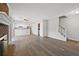 Open-concept living area featuring wood floors, brick fireplace and easy access to the kitchen area at 5555 Clover Rise Ln, Norcross, GA 30093
