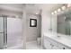 Bathroom featuring a single sink vanity, mirror, shower-tub combo, and white tile flooring at 1204 Village Se Ct, Atlanta, GA 30316