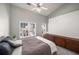 Bedroom with a neutral palette, high ceiling, ceiling fan, carpet, and wooden dresser at 1204 Village Se Ct, Atlanta, GA 30316