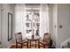 Cozy dining nook with hardwood floors and a bright window with sheer white curtains at 1204 Village Se Ct, Atlanta, GA 30316