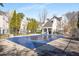 Community pool with a safety cover on it, surrounded by well-maintained townhomes and greenery at 1204 Village Se Ct, Atlanta, GA 30316