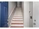Inviting staircase features hardwood treads and a crisp white runner, enhancing the home's interior at 1204 Village Se Ct, Atlanta, GA 30316