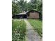 Expansive backyard with a walkway leading to the charming cedar-shake home at 1954 Oak Grove Ne Rd, Atlanta, GA 30345