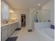 Luxurious bathroom with a soaking tub, frameless glass shower, and double vanity sinks at 325 Caledonia Ct, Peachtree City, GA 30269