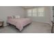 Spacious bedroom featuring neutral carpet, a comfortable bed, and plenty of natural light from the large windows at 325 Caledonia Ct, Peachtree City, GA 30269