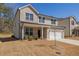 Charming two-story home with brick and siding exterior, well-maintained lawn, and attached garage at 325 Caledonia Ct, Peachtree City, GA 30269