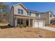 Charming two-story home with brick accents, a covered front porch, and a well-maintained lawn at 325 Caledonia Ct, Peachtree City, GA 30269
