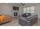 Spacious living room with a stone fireplace, large windows, and contemporary furnishings at 325 Caledonia Ct, Peachtree City, GA 30269