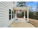 Covered back porch with string lights and ceiling fan, adjacent to the house at 72 Summer Nw Pl, Cartersville, GA 30121