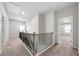 Hallway with carpet flooring, wooden and iron railing, and a view into another room at 72 Summer Nw Pl, Cartersville, GA 30121