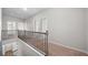 Hallway with black railing and beige carpet at 72 Summer Nw Pl, Cartersville, GA 30121