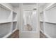 Bright walk-in closet with custom shelving and carpet flooring at 72 Summer Nw Pl, Cartersville, GA 30121