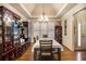 Formal dining room with hardwood floors, elegant furnishings, and a tray ceiling at 9369 Kraft Dr, Villa Rica, GA 30187