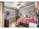 Bedroom features a ceiling fan, hardwood floors, and window for natural light at 9369 Kraft Dr, Winston, GA 30187
