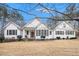 Charming single Gathering home with red front door and white painted wood facade and dark shutters at 9369 Kraft Dr, Winston, GA 30187
