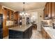 Modern kitchen features granite countertops, black island, tile backsplash, and stainless steel appliances at 9369 Kraft Dr, Winston, GA 30187