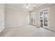 Bright bedroom with neutral carpet and french doors leading to a balcony at 1059 Hedge Rose Ne Ct, Atlanta, GA 30324