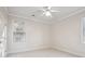 Neutral bedroom with a ceiling fan, carpet floors and two windows at 1059 Hedge Rose Ne Ct, Atlanta, GA 30324