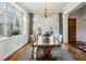 Bright dining room featuring a large table, chandelier, and expansive windows at 1059 Hedge Rose Ne Ct, Atlanta, GA 30324