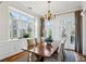 Sunlit dining room showcasing a chandelier, neutral drapes, and a large bay window at 1059 Hedge Rose Ne Ct, Atlanta, GA 30324