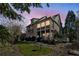 Charming home showcasing a two-story porch, manicured lawn, and mature trees, creating a serene backyard retreat at 1059 Hedge Rose Ne Ct, Atlanta, GA 30324