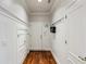 Well-lit hallway featuring hardwood floors, wainscoting, and convenient coat hooks at 1059 Hedge Rose Ne Ct, Atlanta, GA 30324