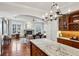 Open-concept gourmet kitchen leading to the Gathering room with a fireplace at 1059 Hedge Rose Ne Ct, Atlanta, GA 30324