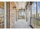 Relaxing screened porch with brick accent wall, wood flooring, and ceiling fan at 1059 Hedge Rose Ne Ct, Atlanta, GA 30324