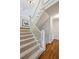 Carpeted stairs with white banister and wood floors lead to upper level at 1059 Hedge Rose Ne Ct, Atlanta, GA 30324