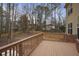 View of the home's back deck overlooking the wooded backyard, complete with a wooden fence and bare trees at 1554 Sage Ridge Dr, Marietta, GA 30064