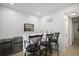 Cozy bar area with mini-fridge, metal shelving, white countertops and black barstools at 1554 Sage Ridge Dr, Marietta, GA 30064