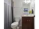 Small bathroom featuring a toilet, sink with dark wood cabinet, shower and neutral colors at 1554 Sage Ridge Dr, Marietta, GA 30064