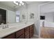 Bathroom with dark wood vanity featuring dual sinks and a view into the primary bedroom at 1554 Sage Ridge Dr, Marietta, GA 30064