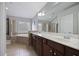 Bathroom featuring a soaking tub, walk-in shower, double vanity with wood cabinets and a large mirror at 1554 Sage Ridge Dr, Marietta, GA 30064