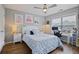 Bedroom featuring a large bed, desk, nightstand and artwork, lit by a ceiling fan at 1554 Sage Ridge Dr, Marietta, GA 30064