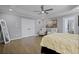 Large bedroom with hardwood floors, a tray ceiling, and ample natural light from the large windows at 1554 Sage Ridge Dr, Marietta, GA 30064