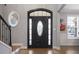 A foyer with a dark-stained front door, decorative sidelights and transom, and a view of the staircase at 1554 Sage Ridge Dr, Marietta, GA 30064